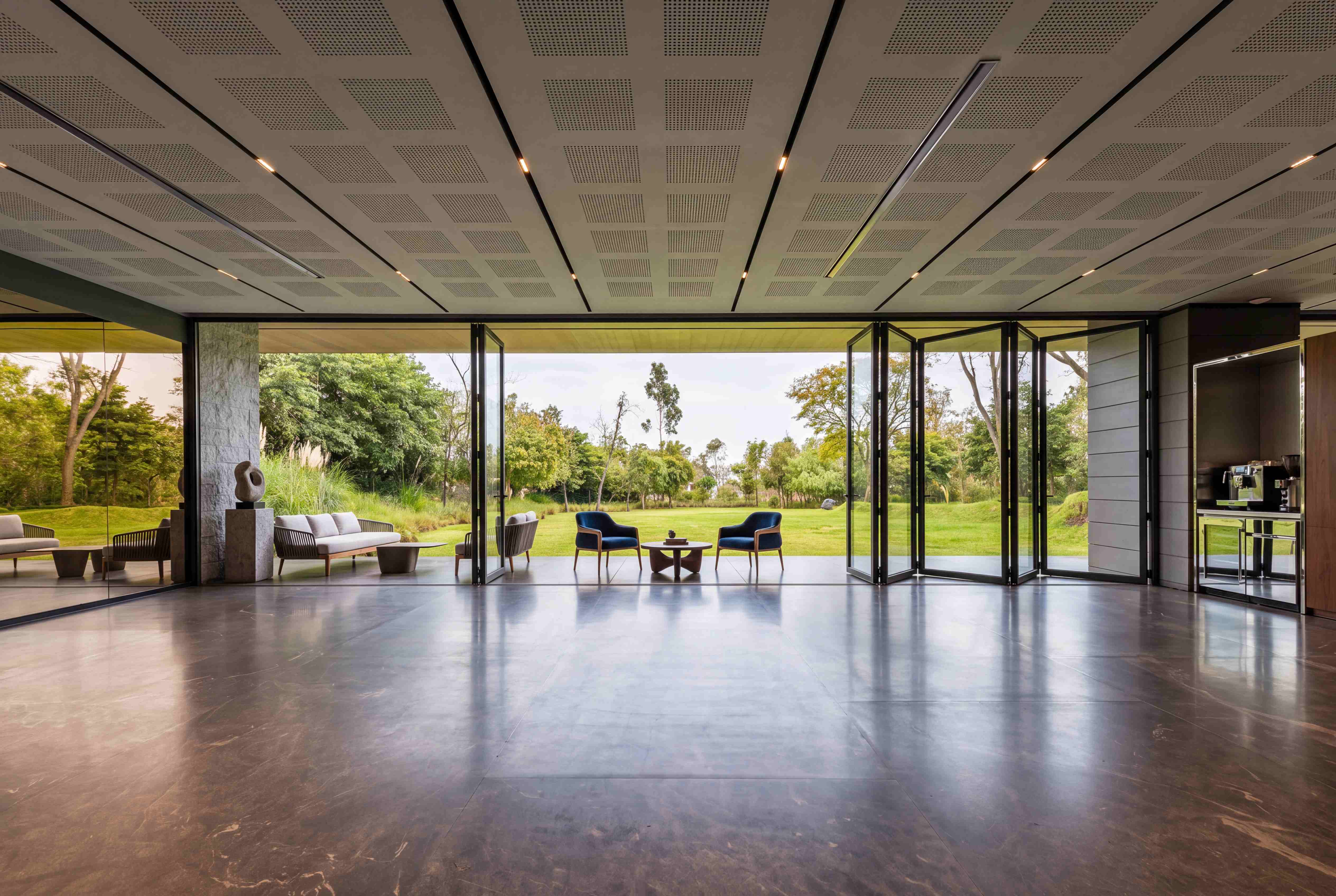 Slim-framed aluminium bi-fold doors opening a Westminster home onto its garden